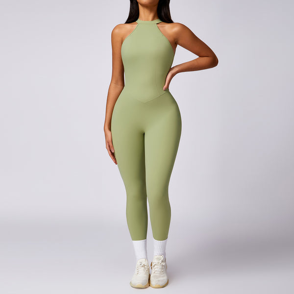Woman wearing green backless yoga jumpsuit with slim fit design for workout