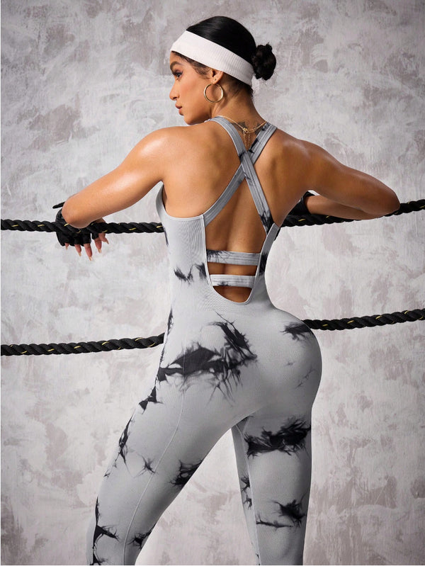 Woman wearing gray and black abstract print VIREA one-piece fitness jumpsuit with cutout back design”