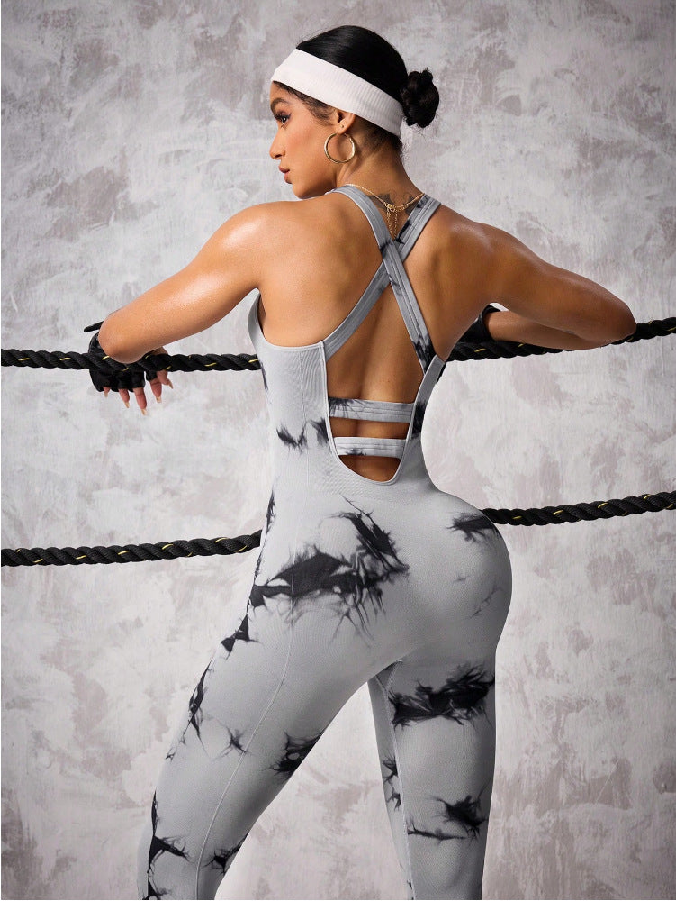 Woman wearing gray and black abstract print VIREA one-piece fitness jumpsuit with cutout back design”