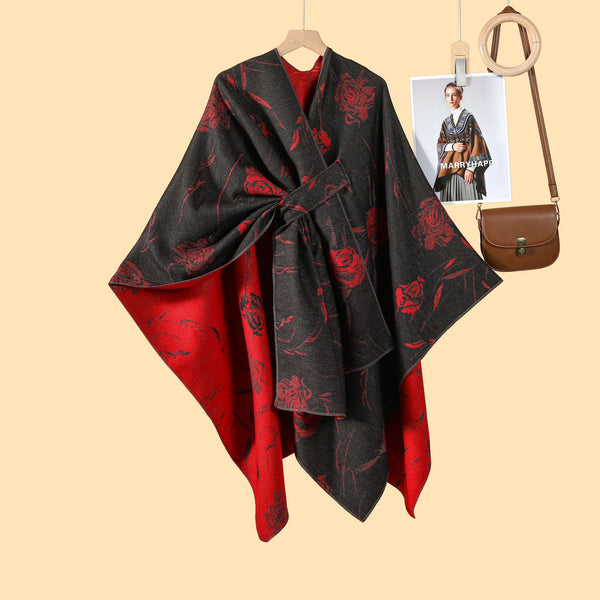 Model wearing black rose-printed cloak with red inner lining”